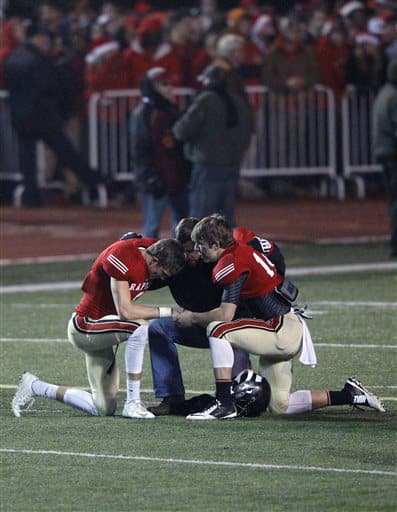 Students kneeling in prayer