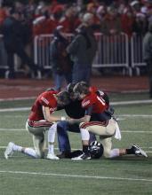 Students kneeling in prayer