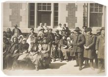 A Group of Immigrants Outside a Building on Ellis Island